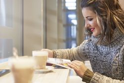 cheerful woman reading travel guide