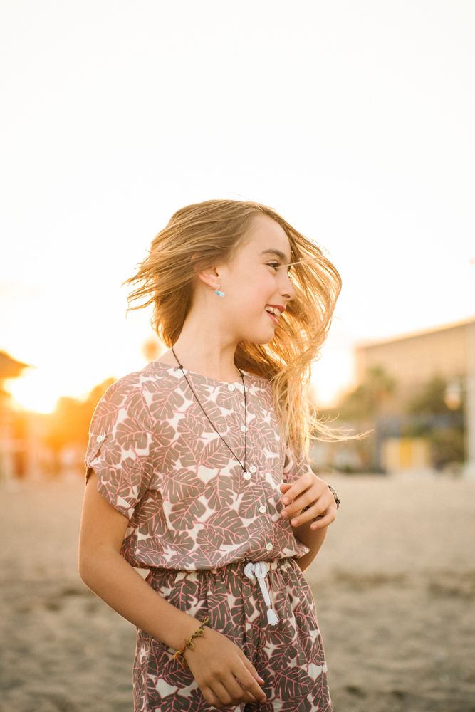 Laughing girl in sunset on beach