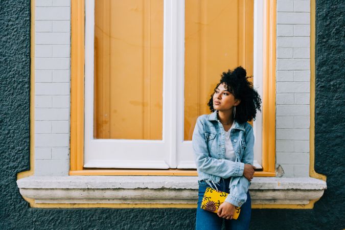 Smiling female by yellow window