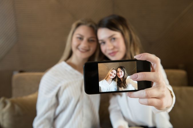 Young women taking selfie in cafe