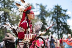 Red Wing, MN, USA - July 8th, 2017: Native American person in headdress at Pow Wow