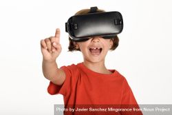 Happy girl looking in VR glasses and gesturing with finger pointing up 47v1a5