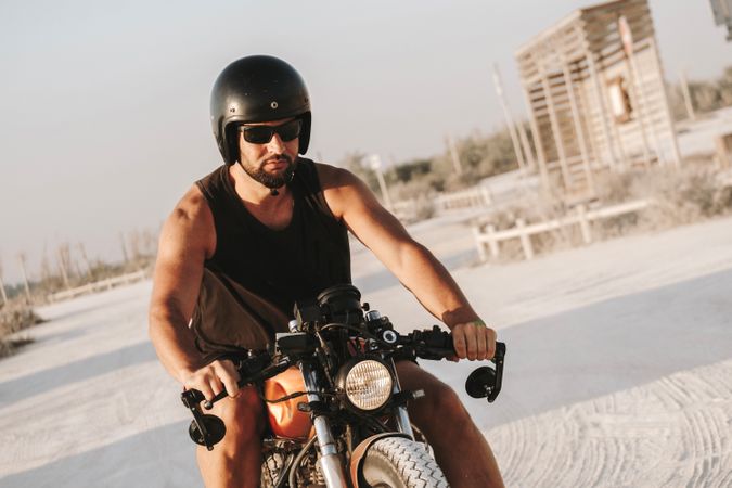 Strong man driving motorcycle