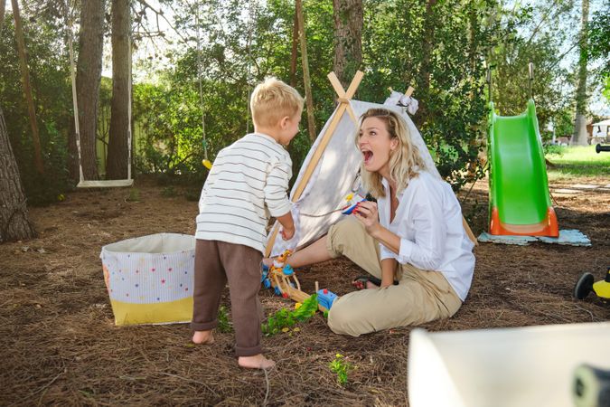 Mother and son playing with toy in park