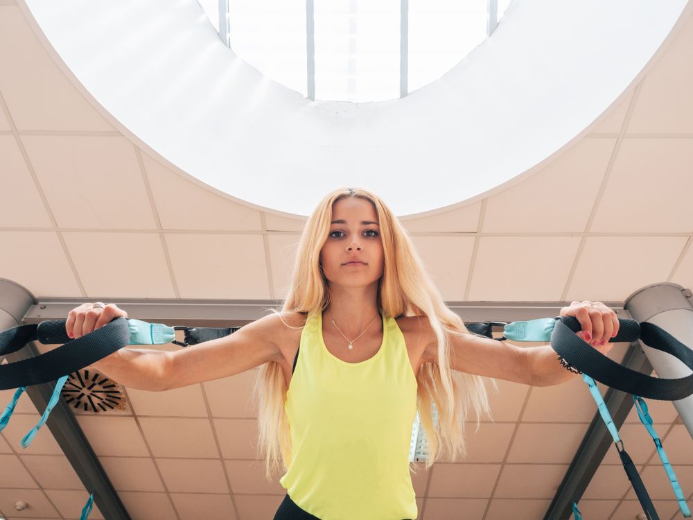 Young female having suspension training