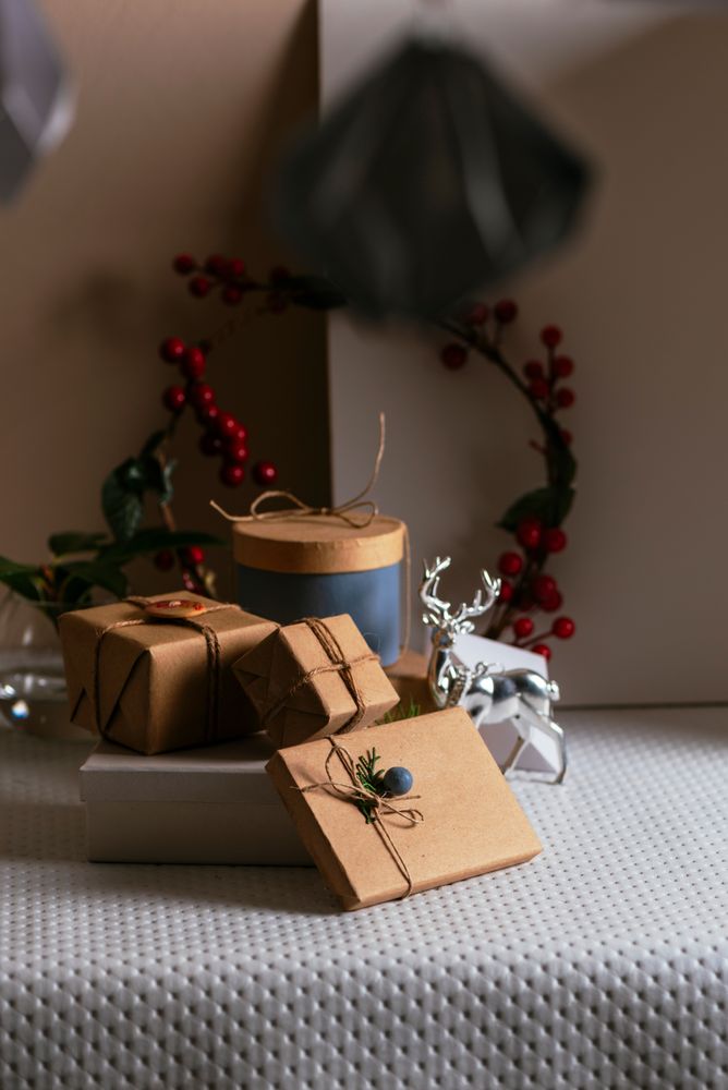 Gifts boxs wrapped in recycled paper, stacked on the decorative festive table