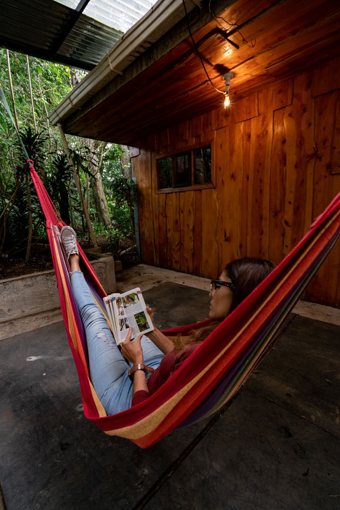 Woman lying on hammock and reading a book outdoor