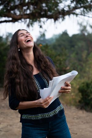 Female director laughing while holding script