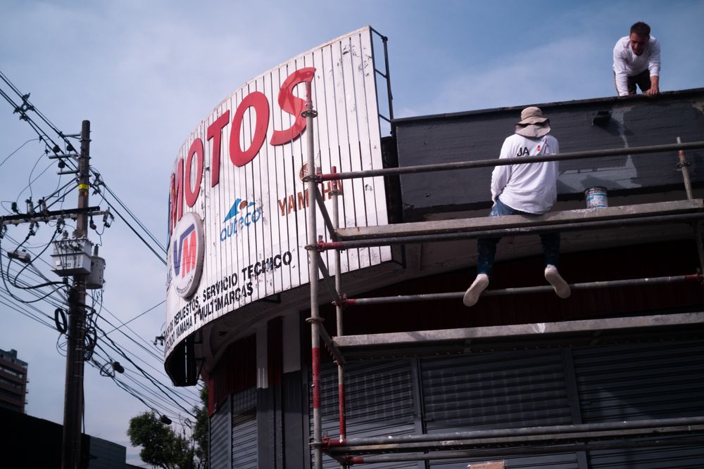 Two men working on an billboard