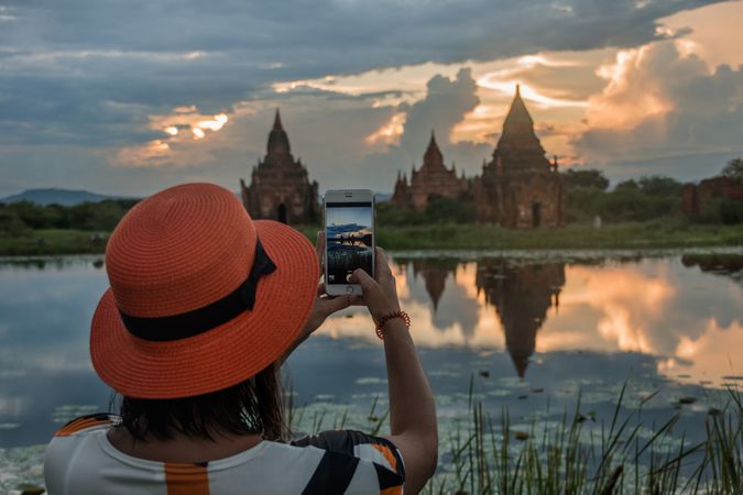 Female tourist taking picture of temples