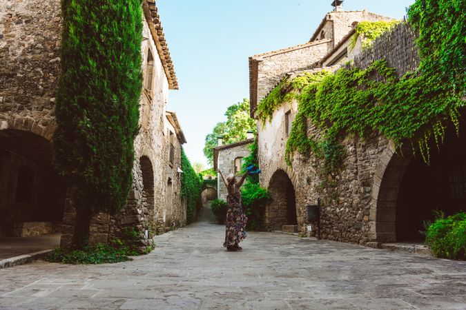 Woman walking in a narrow path in a village
