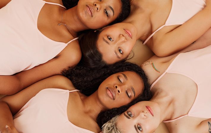 Multi-ethnic women lying next to each other