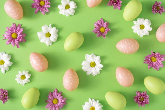 Flowers, green and brown eggs on pastel pink background