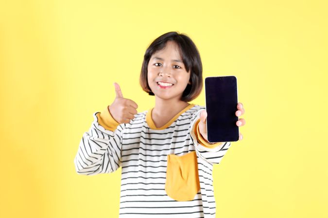 Asian Kid Holding Blank Screen of Mobile Phone