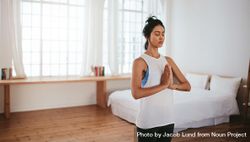 Fitness female meditating indoors 0gdgN5