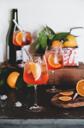 Aperol Spritz aperitif alcohol drink in glasses with orange slices and bottle