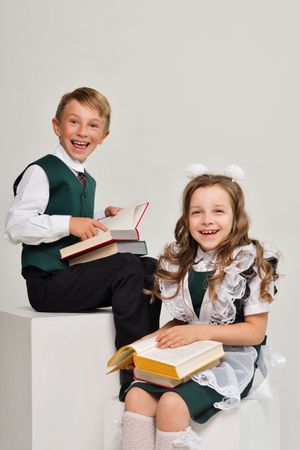 Uniform elementary school students read paper books with interest