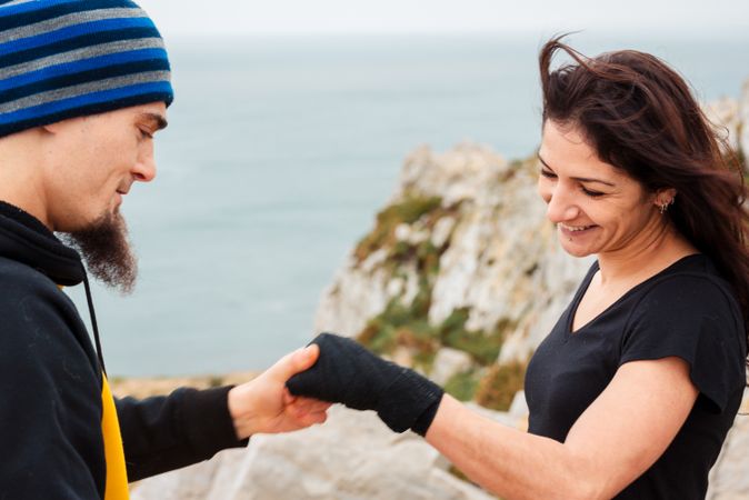 Kickboxers bandaging hands before outdoor training