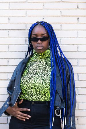 Determined Black woman in trendy clothes in city