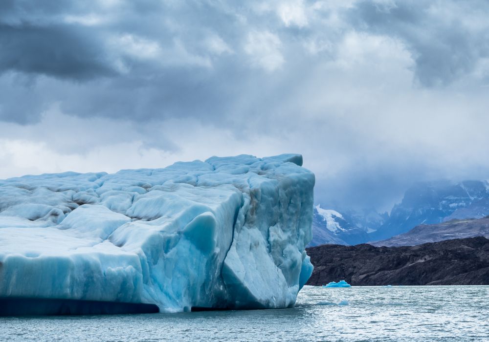 Iceberg against overcast sky