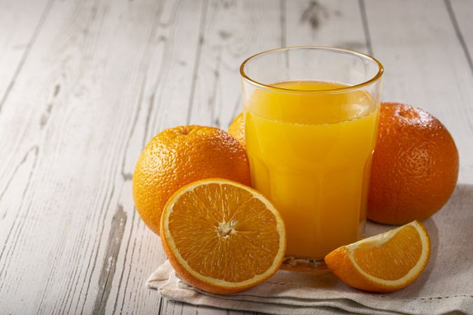 Glass with orange juice on the table.