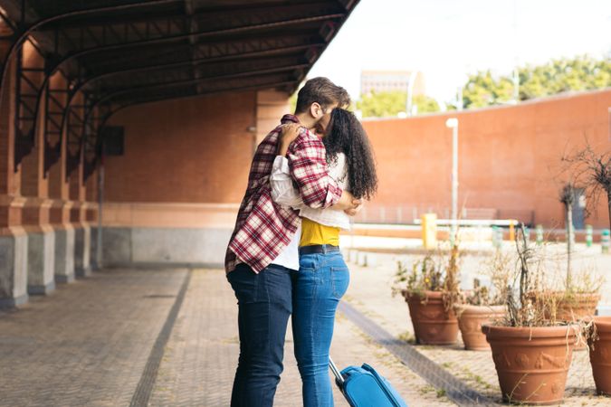Young couple meeting at the train station after a trip