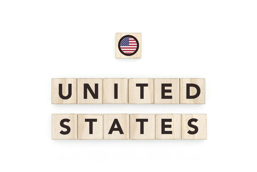 Wooden blocks bearing the name and flag of United States. American Culture, national identity, travel, and geography in a copy space design.