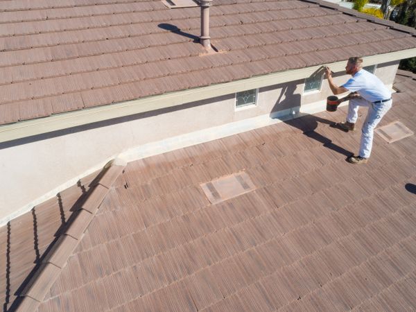 Professional Painter Using A Brush to Paint House Fascia