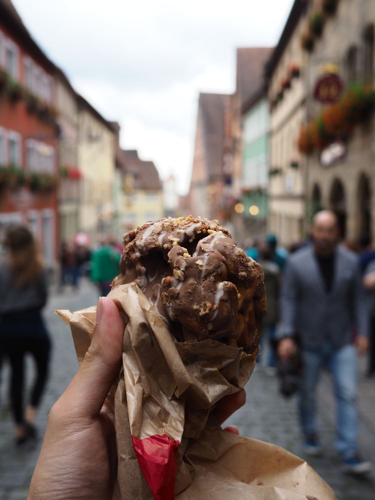 a Delicious Chocolate Waffle Ice Cream with crowd in a soft-focus street situation in the background.