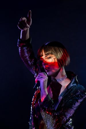 Stylish woman singing on stage