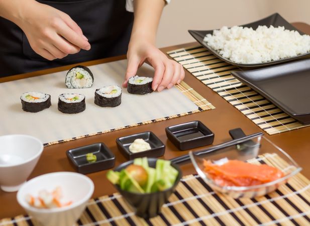 Chef arranging freshly made sushi rolls