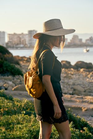 Woman traveler in straw hat walking