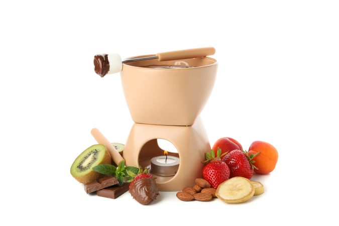 Bowl and ingredients for chocolate fondue isolated on plain background