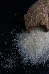 sugar spilling from a burlap sack
