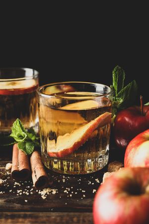 Composition with cider, sugar, cinnamon and apples on wooden table