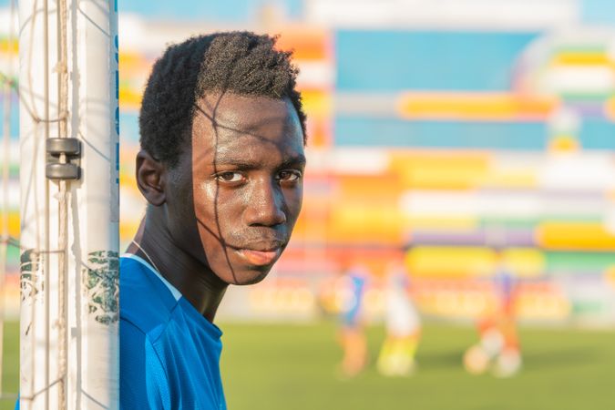 Black football player near net