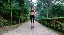 Woman jumping with skipping rope in a park