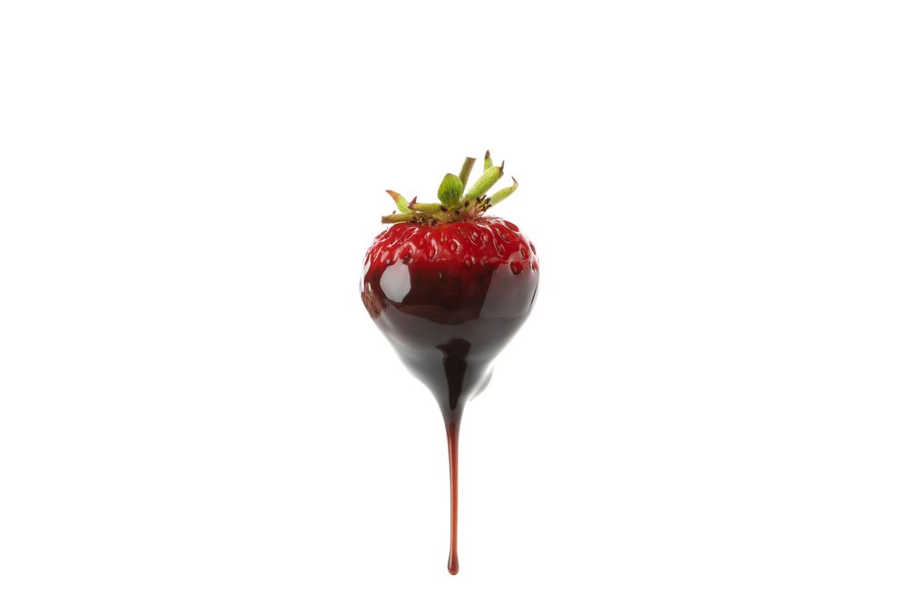 Chocolate fondue. Strawberry in chocolate sauce isolated on plain background