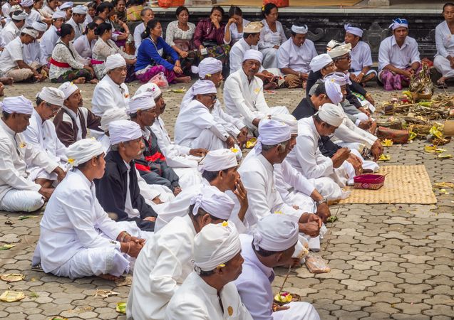 Bali, Indonesia - August, 15 2015: People praying on temple yard