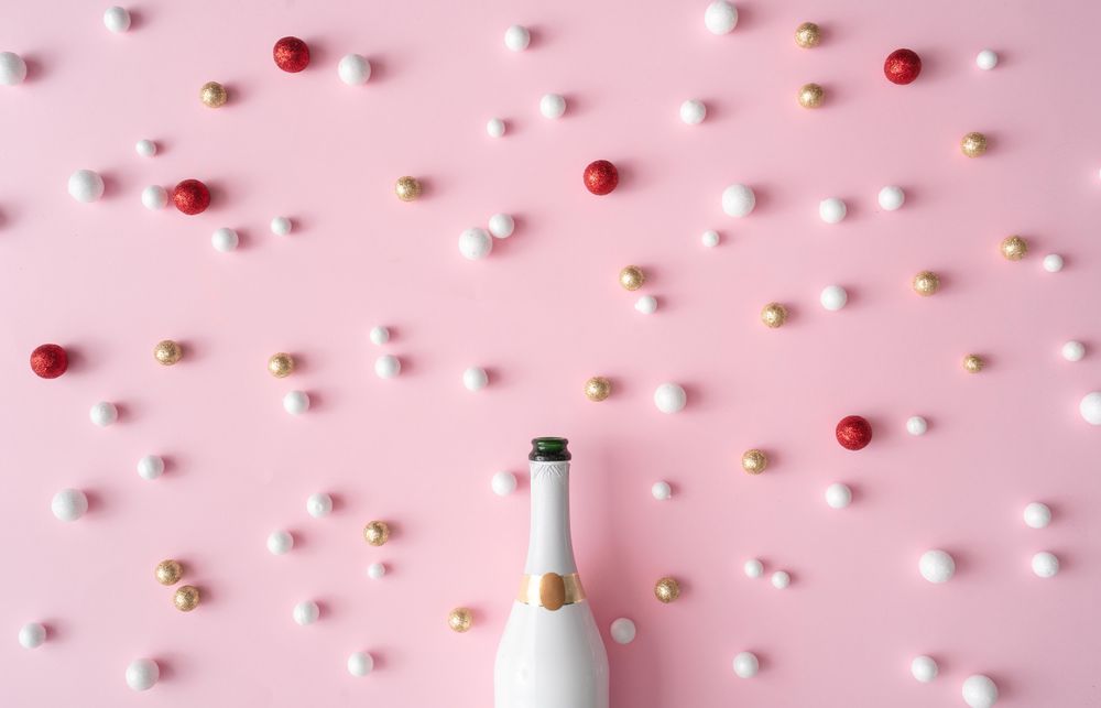 Champagne bottle with red, gold and shiny glitter decoration balls