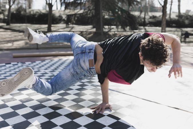 Man dancing break dance in park