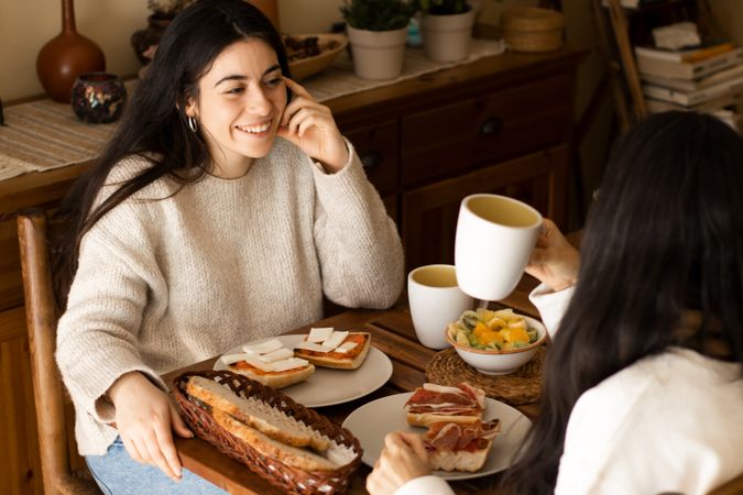 young woman having breakfast with her mother.