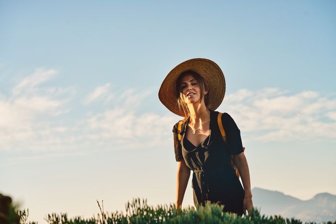 Woman traveler in straw hat walking