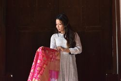 Woman in light dress looking at her sari