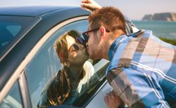 Young couple kissing through the glass