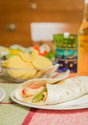 Traditional mexican food with a plate of chicken fajita, fresh salad and a bowl of nachos