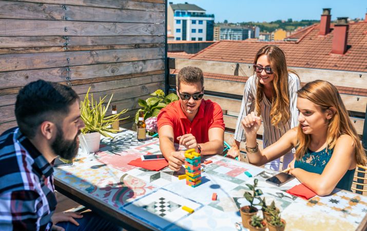 Group of friends playing with game in rooftop on a summer party