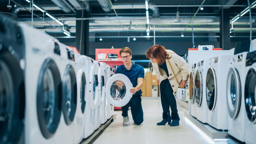 Customer Explores Laundry Appliance Options. Shopper in Modern Retail Shop