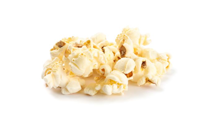 Popcorn pile isolated on blank background, close up