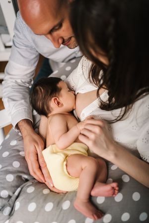 Mother feeding baby at home